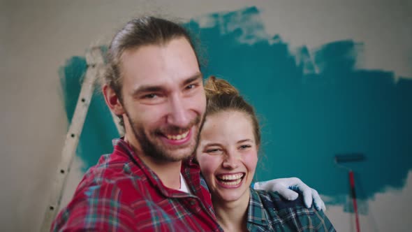 Excited Couple at Home While Painting the Walls