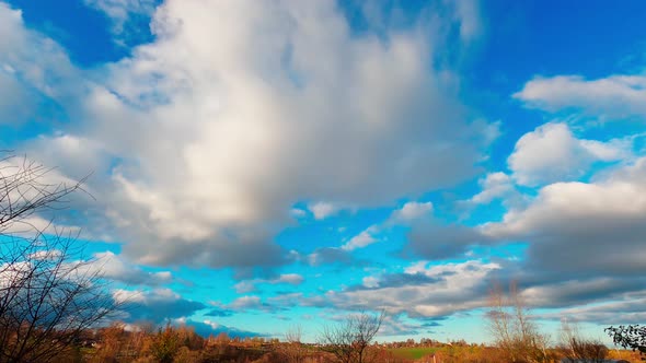 Abstract countryside landscape time lapse with white clouds in the blue sky