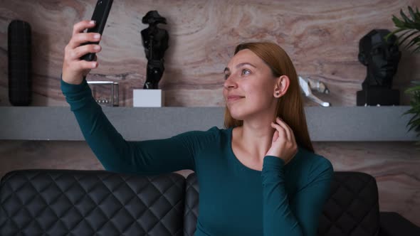 Business Woman Takes a Selfie on Her Phone.