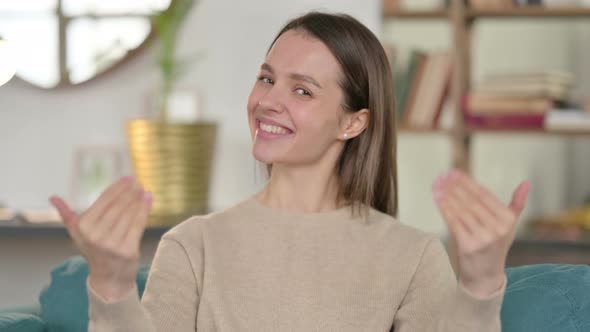 Portrait of Young Woman Pointing and Inviting 