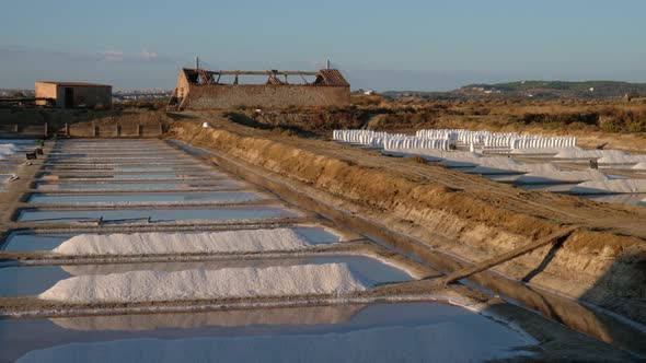 Sunset cinematic shot of salt fields after a full day of collecting salt. Salt extraction