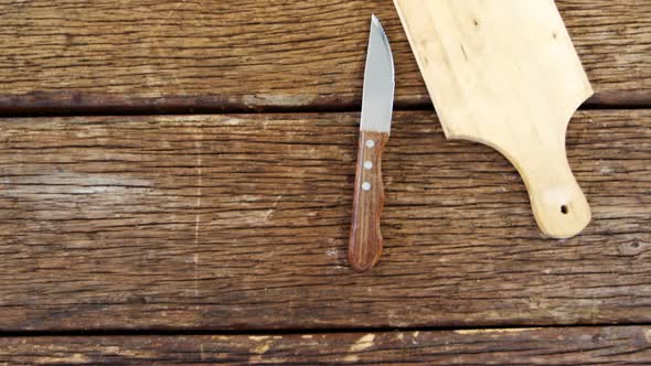 Knife and chopping board on table
