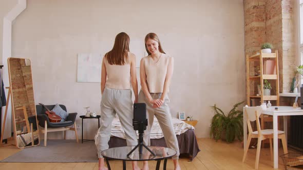 Identical Twin Sisters Laughing and Filming Video