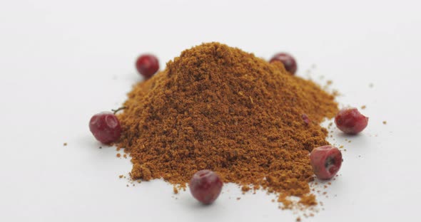 Red Pepper Powder Rotation. Macro Shot Against a White Background