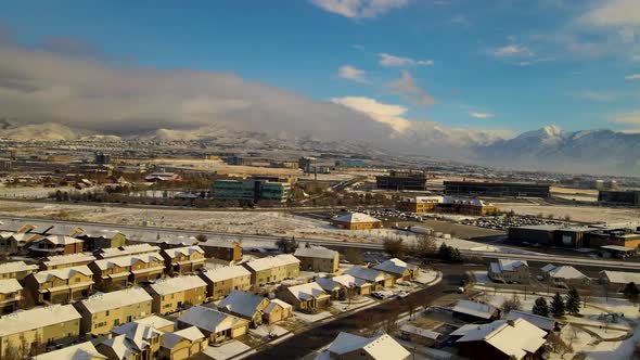 Silicon Slopes in Lehi, Utah on a winter day with a fresh layer of snow over the city - aerial paral