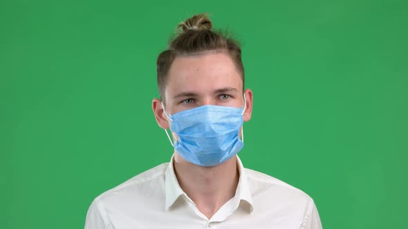Portrait of Man Wearing Medical Mask on Chroma Key Background.
