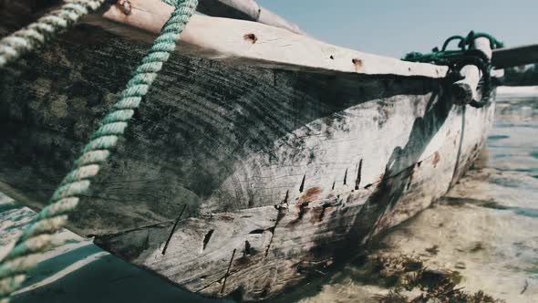 Old Dry African Fishing Rowboat Stranded in Sand on Beach at Low Tide Zanzibar