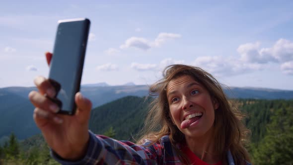 Woman Taking Selfie on Smartphone in Mountains