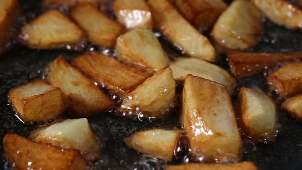 Close up view of Frying Fresh Raw chopped Potatoes In Pan