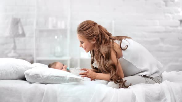 Attractive Happy Woman Having Fun Stroking Cute Child Enjoying Morning Together at Home