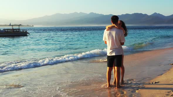 Teenage lovers sunbathe on luxury bay beach journey by clear water and white sandy background of Gil