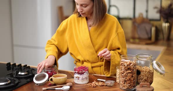 Woman Making Cereal Breakfast on the Kitchen at Home