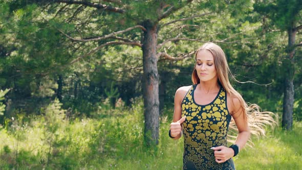 CU, Portrait: Young Girl Goes in for Sports in the Morning, Runs Along a Pine Forest