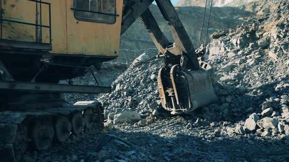 Excavator Bucket is Grabbing Crushed Ore