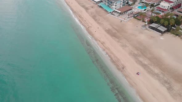 Golden sandy beach without tourists, aerial drone view