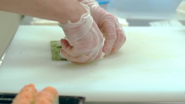 Cook Puts a Layer of Rice on the Nori Seaweed Prepares the Japanese Roll