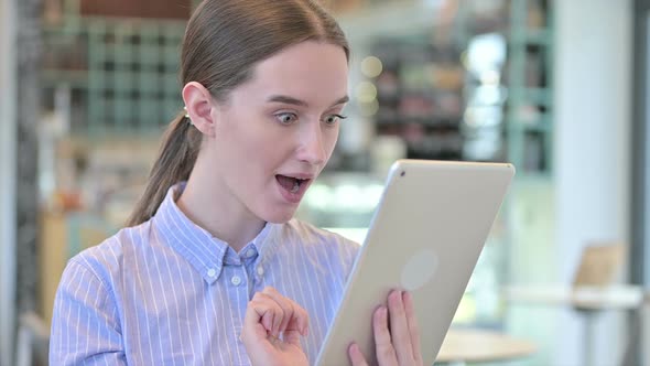 Portrait of Success on Tablet By Young Businesswoman Celebrate