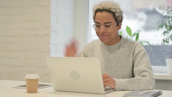 African Woman Talking on Video Call on Laptop in Office