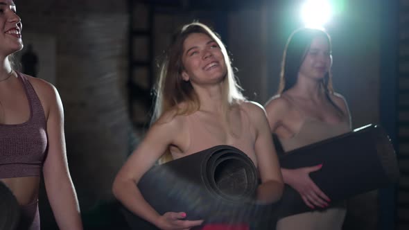 Cheerful Smiling Young Women Walking in Darkness with Backlit Flash Talking in Slow Motion