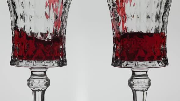 Rose Wine. Red Wine Pour in Two Wine Glasses Over White Background