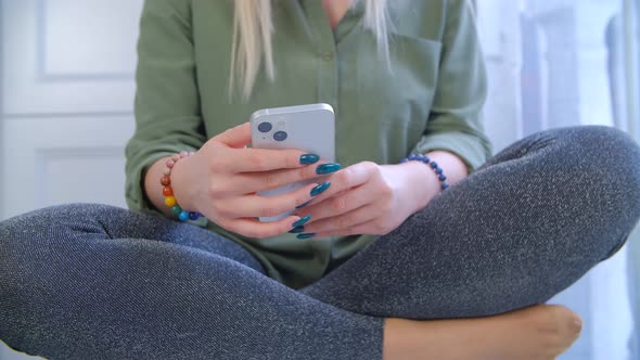 Girl browsing internet on mobile phone. Woman using modern smartphone for entertainment