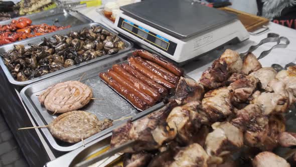 Grilled Meat and Vegetables in a Street Shop Window. Food Court with Grilled Meals