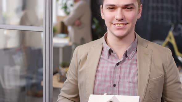 Portrait of Man Holding Model of House and Posing