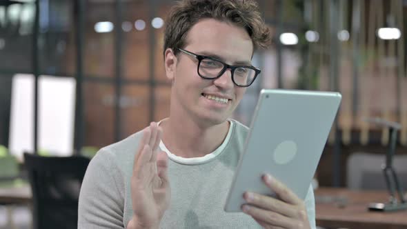 Portrait Shoot of Cheerful Guy Doing Video Chat on Tablet