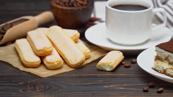 Portion of Traditional Italian Tiramisu Dessert Cup of Espresso and Savoiardi Cookies