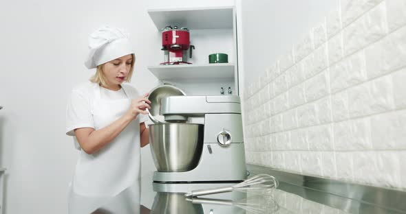 Beautiful Female Chef Kneads Baking Dough