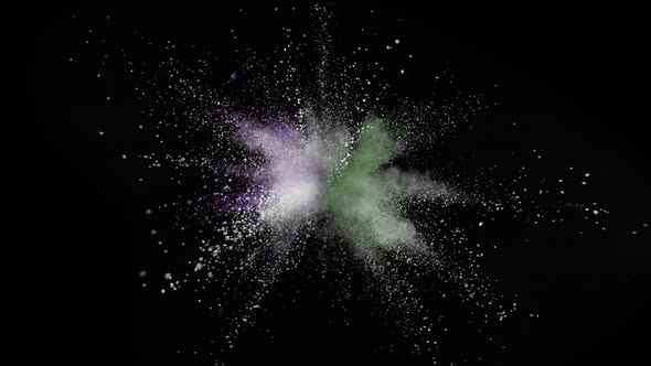 Colorful powder/particles fly after being exploded against black background. Slow Motion.