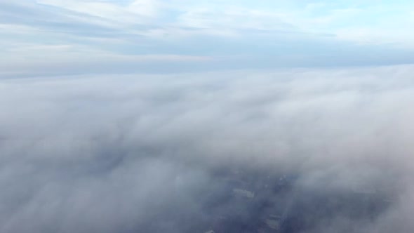 Aerial Drone View Flight Over Above Fog Mist and Roofs of Buildings in City
