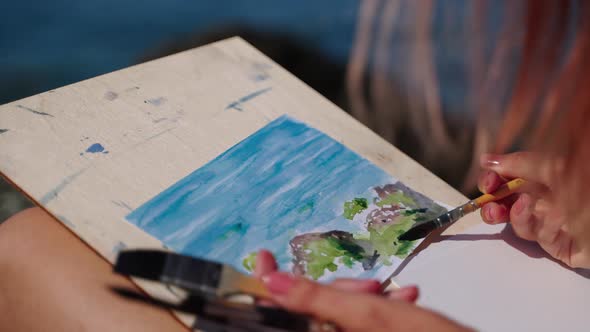 Drawing Seascape By Aquarelle Woman is Practicing Her Creative Hobby