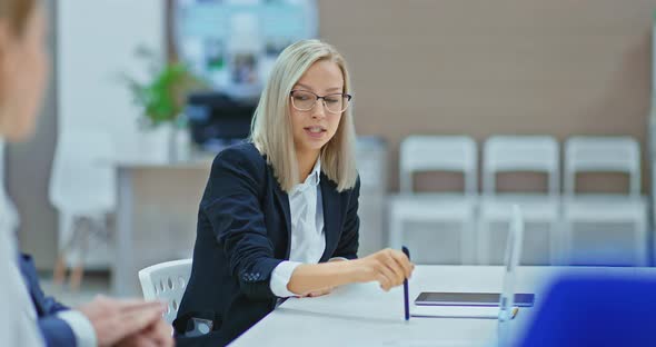 Portrait of a Woman Director in a Formal Suit and Glasses She is Talking with Business Partners and