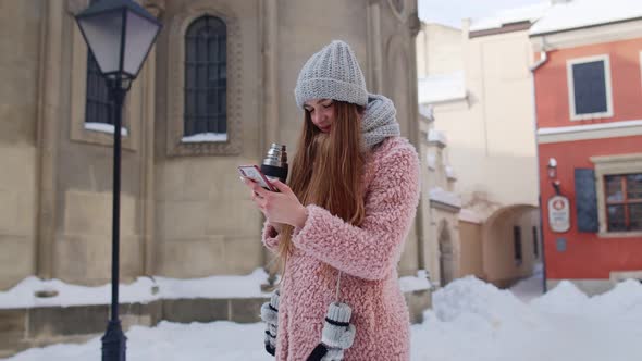 Traveler Woman Holding Mobile Phone Chatting with Friends and Family Drinking Hot Drink Tea