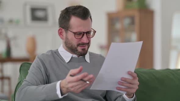 Middle Aged Man Having Loss While Reading Documents