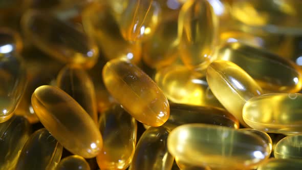 Cod Liver Oil Omega 3 Gel Capsules on a Black Mirror Surface