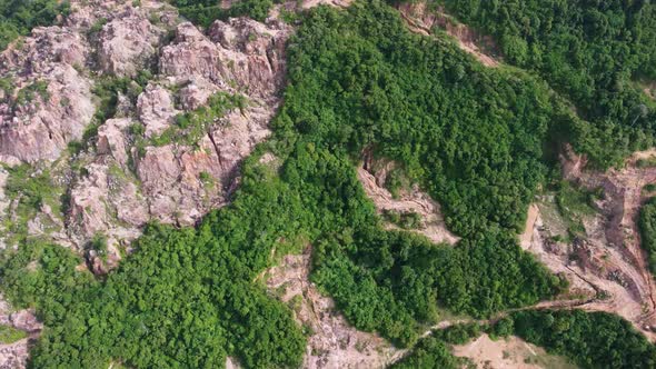 Aerial view red clay soil after mining near forest