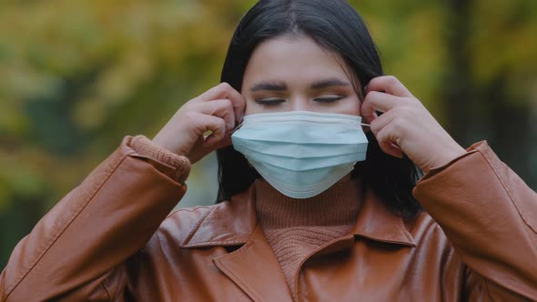 Closeup Young Woman Stands Outdoors in Park Takes Off Medical Protective Mask From Face Throw