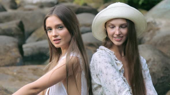 Two beautiful girl posing in forest