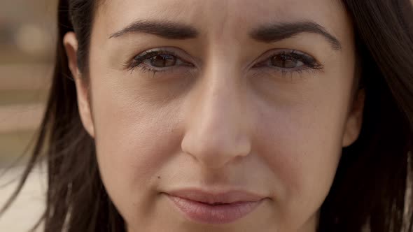 Outdoor Portrait of a Hispanic Woman Looking at the Camera with a Serious Face