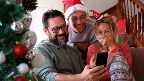 Happy caucasian family at home celebrating together Christmas Eve day