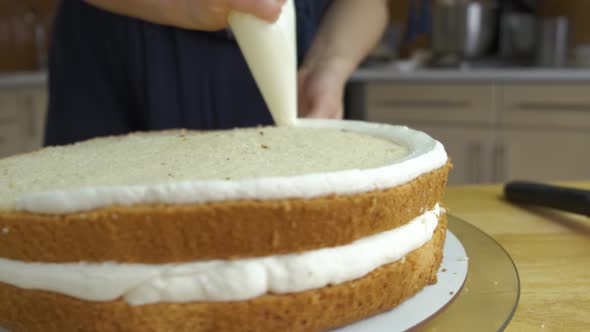 Close Up of Woman Hands Making Sweet Cake with White Cream and Biscuit