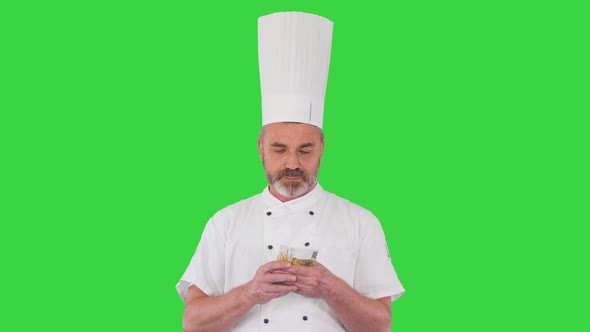 Restaurant Business Excited Chef Man Holding Money on a Green Screen Chroma Key