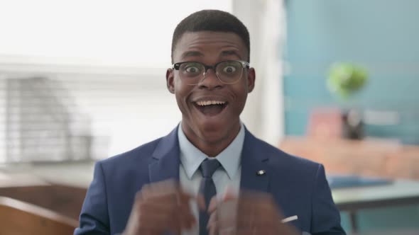 Excited Young African Businessman Celebrating Success