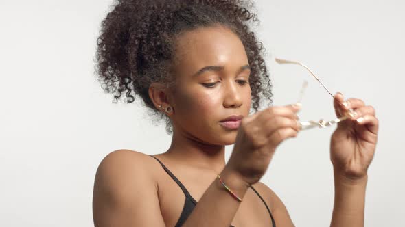 Closeup Portrait s of Young Mixed Race Model with Curly Hair in Studio with Natural Neutral Makeup