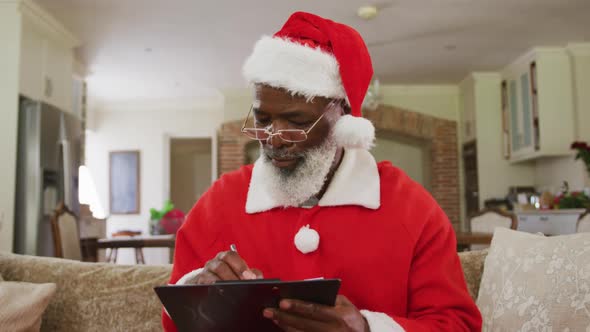 Senior african american man wearing santa costume at christmas time