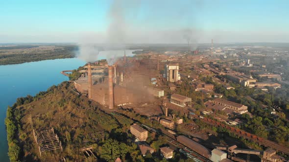 Aerial View of the Industrial Plant with Smoking Pipes Near the City Industrial Zone