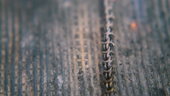 Jeweler Covers Gold Chain with Material on Asbestos Closeup