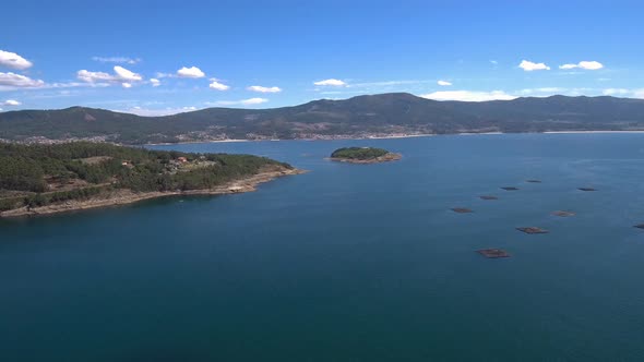 Aerial View Of Illa De Creba With Mussel Seafood farms in Ria Muros y Noya Galicia Spain. Dolly Forw